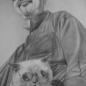 A man holding a cat in his arms.