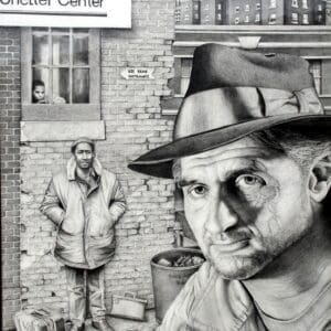 A man in hat and fedora standing next to brick building.