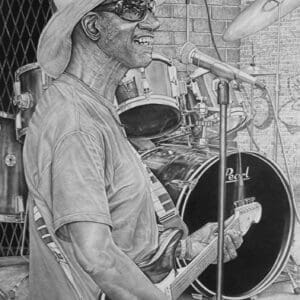 A man with a hat on playing drums