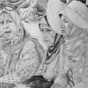 Three women in a group of people sitting on the ground.